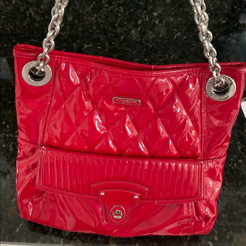 Coach satchel with combo leather and chain handle.